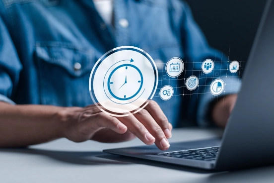 An image of a person typing on a laptop keyboard. Overlaid is a graphic representation of a stop watch