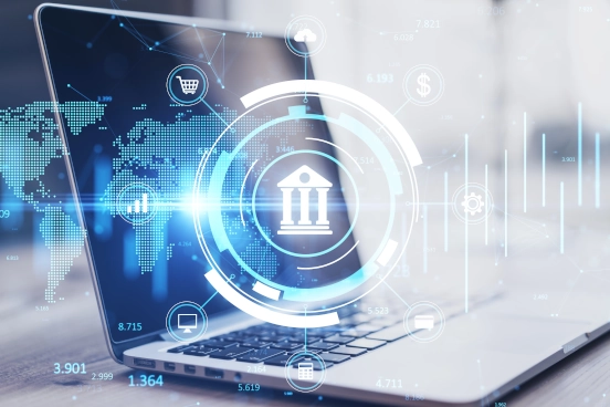 An image of a laptop computer on a desk with a bank logo in white superimposed over the top