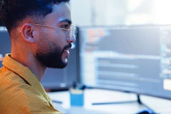 A close up picture of a person working at a computer screen