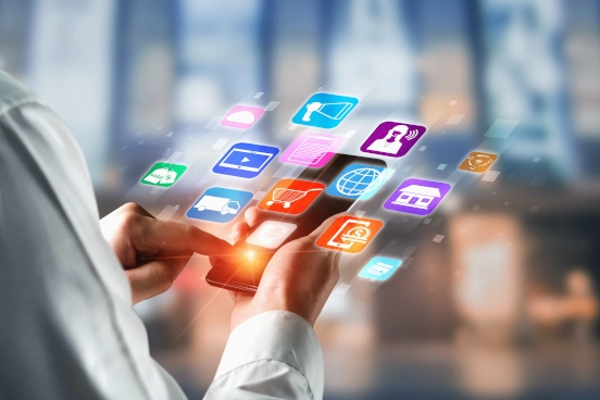 A photograph of a person holding a phone. Hovering above the phone are graphical icons in different colours representing different activities